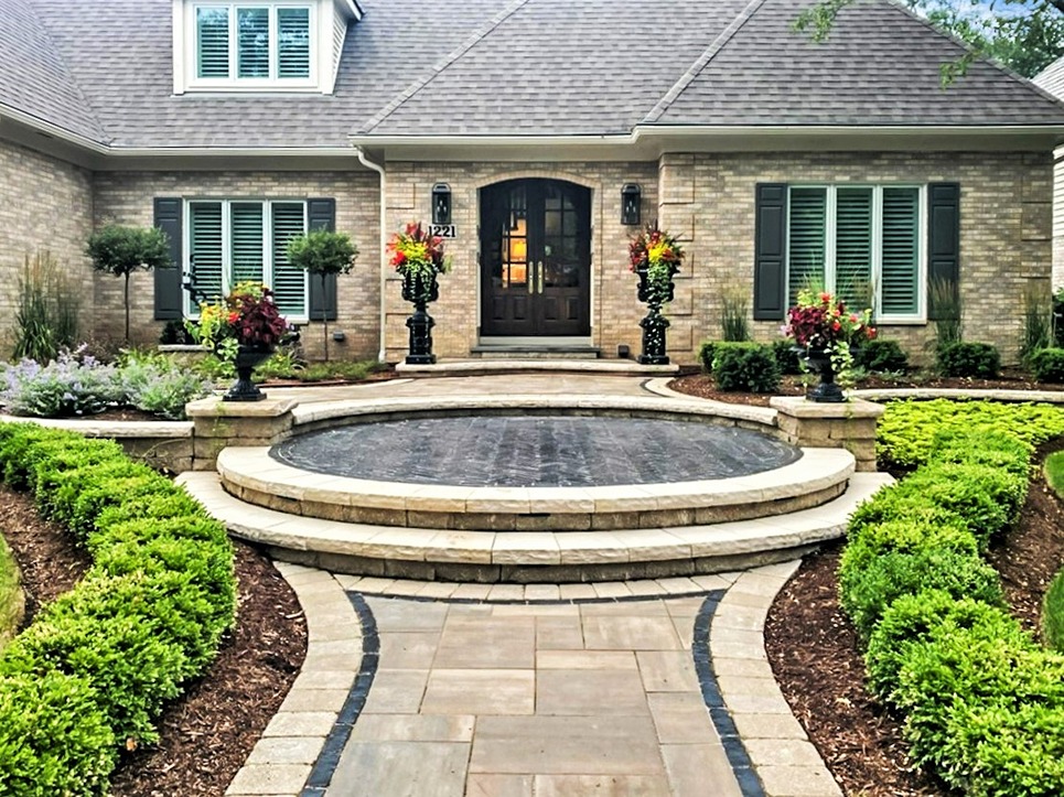 Grand entrance to a Naperville home with a multi-step walkway and softscaping featuring tall planters.