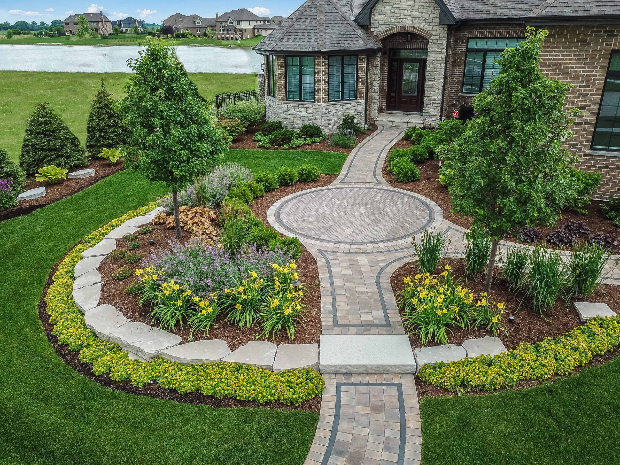 Hardscapes, brick pavers and plantings will enhance the entryway to your home.
